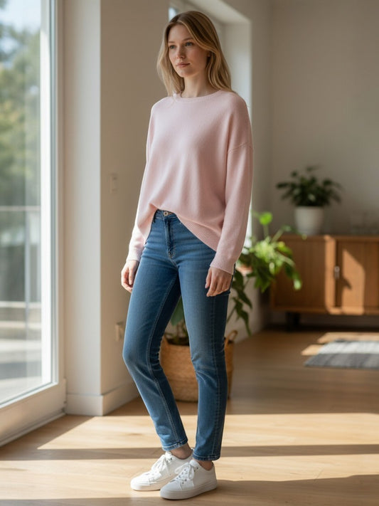 CLEMENTI light pink viscose blend crew neck sweater with ribbed cuffs and hem, worn by a woman with blue jeans.